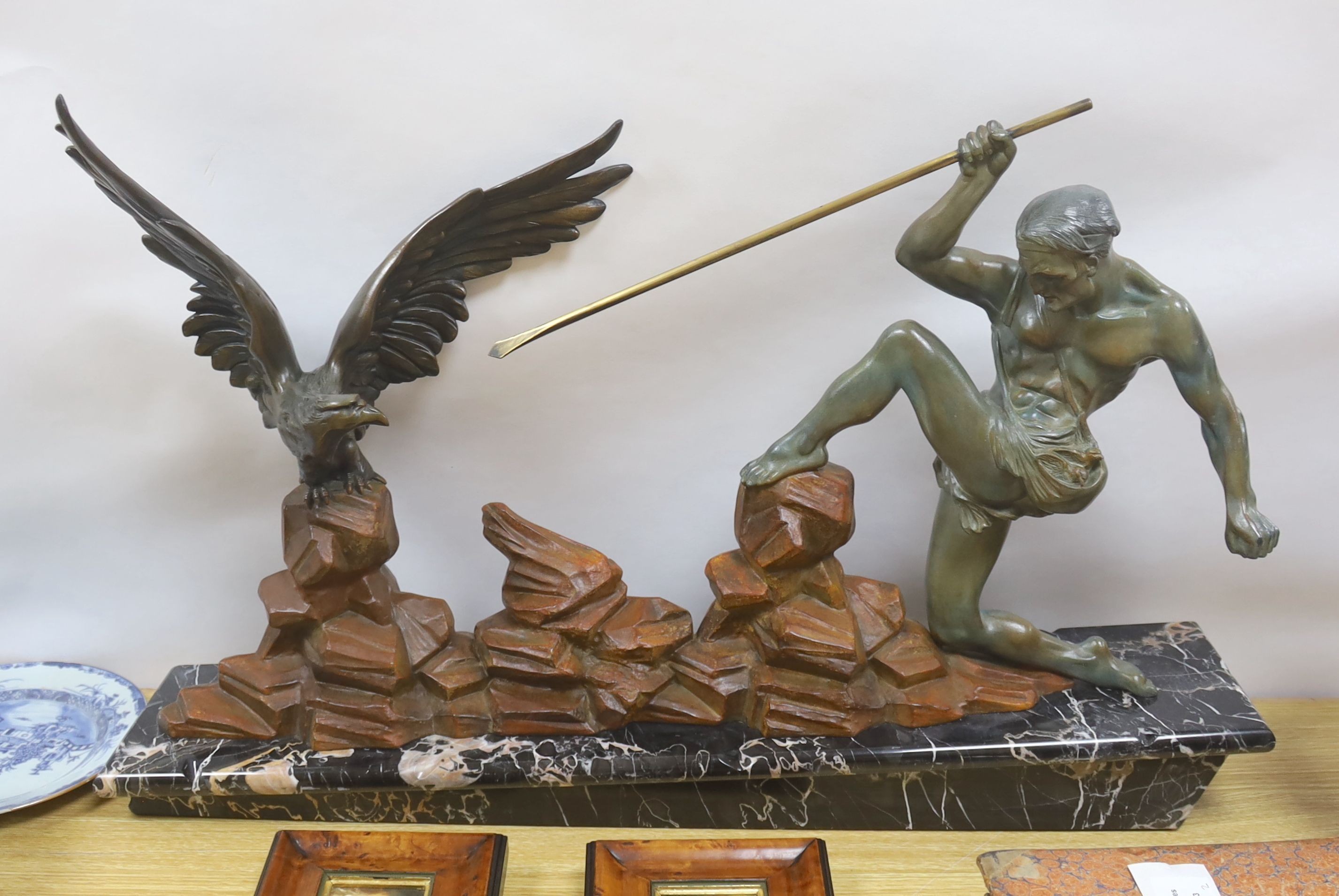 An Art Deco patinated spelter model of a hunter and eagle on a marble base - 77cm